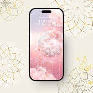 May include: A smartphone shows a pink and white floral wallpaper with a geometric design. The screen displays the date and time. The background features gold mandala patterns on a cream-coloured surface.