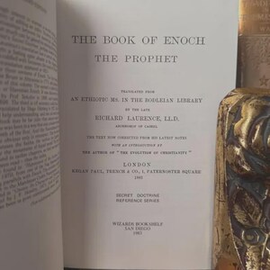 May include: Open book titled "The Book of Enoch The Prophet" with text translated from an Ethiopic manuscript. Published by Kegan Paul, Trench & Co. in London, 1883. Includes "Secret Doctrine Reference Series" and "Wizards Bookshelf, San Diego 1983".