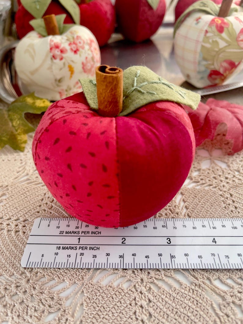 Red patchwork fabric apple shown with ruler for size reference.
