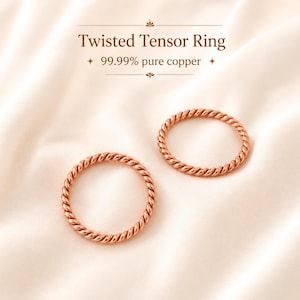 May include: Two circular rings made of 99.99% pure copper with a twisted rope-like texture. The text "Twisted Tensor Ring" and "99.99% pure copper" is printed above the rings in a dark brown font on a light, soft-textured background.