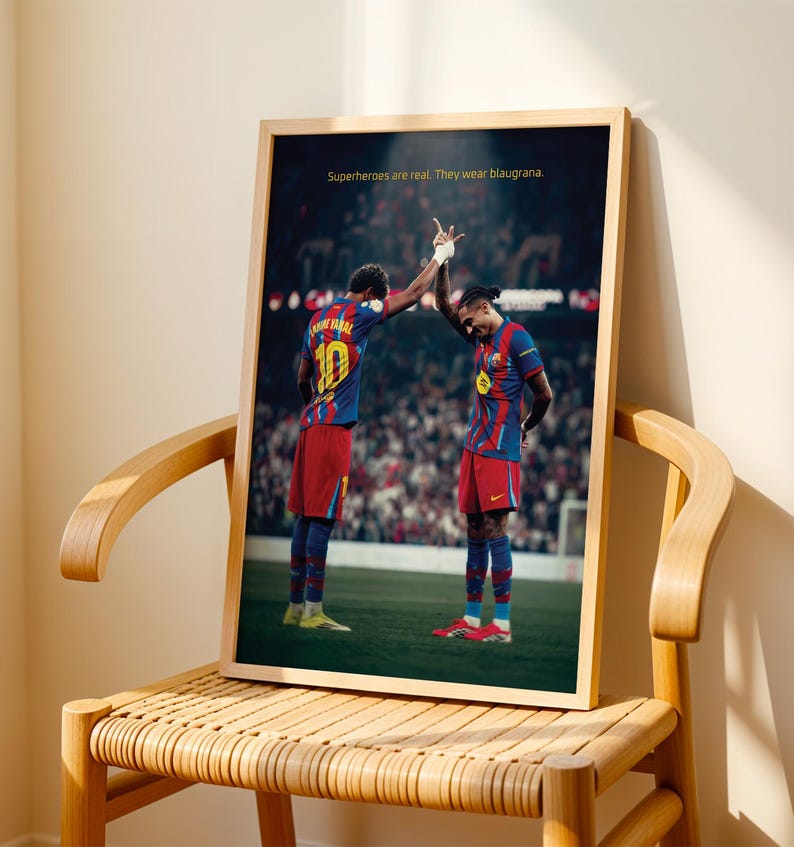 May include: Framed print featuring two soccer players in blue and red uniforms, high-fiving on a green field. The print has the text: "Superheroes are real. They wear blaugrana."