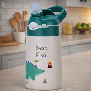 May include: White water bottle with a teal lid and handle. The bottle features a cartoon dinosaur illustration and the words "Best Kids". The bottle is designed for children and has a flip-top lid.