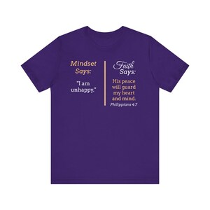 The image is a purple t-shirt with text and a Bible verse from Philippians 4:7 printed on it.