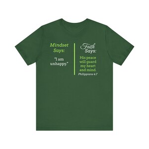 The image is a green t-shirt with text and a Bible verse from Philippians 4:7 printed on it.
