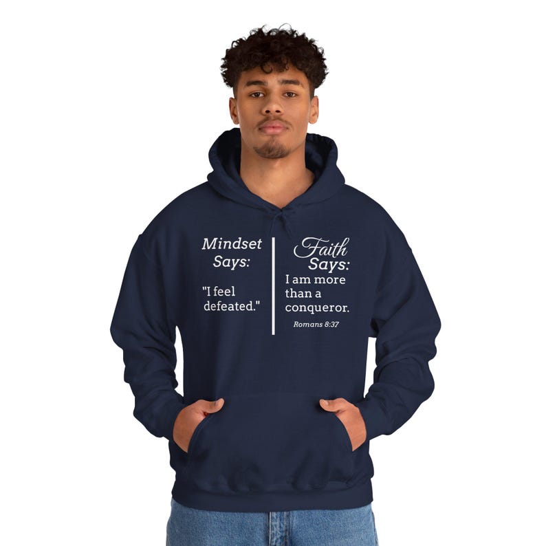 A man wearing a navy blue hoodie with text printed on it.