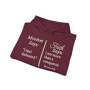 a maroon hoodie with white text and Bible verse references.