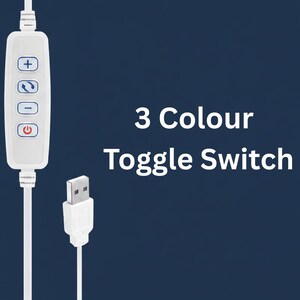May include: A white 3-color toggle switch with a USB connector. The switch has buttons for power, color adjustment, and brightness control. The text "3 Colour Toggle Switch" is displayed in white.