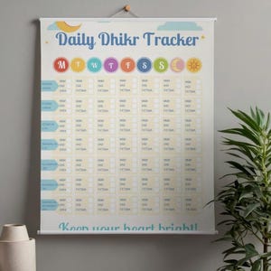 May include: A Daily Dhikr Tracker wall hanging with a light beige background. The top features the title in blue, with colorful circles for each day of the week. Below are rows of boxes for tracking. The bottom reads "Keep your heart bright!"