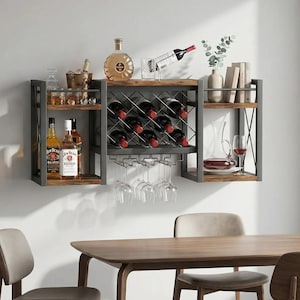 May include: A wall-mounted wine rack with shelves, holding bottles of wine, liquor, and glasses. The rack has a metal frame and wooden shelves. A bottle of cognac and a wine decanter are also visible.