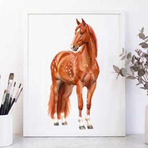 May include: Watercolor painting of a chestnut horse with white spots and a white blaze on its face. The horse is framed in a white border, with paintbrushes in a white cup to the left.
