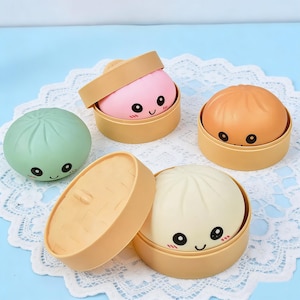 Puede incluir: Un juego de tres tazas de cerámica con acabado mate moteado. Las tazas son de color crema, gris claro y gris oscuro. Cada taza tiene un diseño simple y minimalista, ideal para café o té.