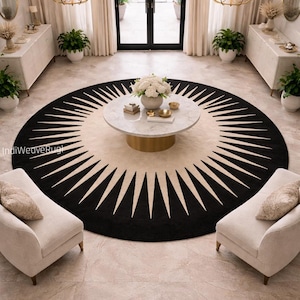 May include: A circular rug with a black and cream sunburst pattern. Two cream armchairs face each other. A marble-topped coffee table is in the centre, and the room is illuminated by chandeliers. The room has a luxurious feel.