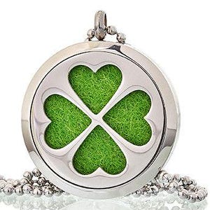 May include: A silver pendant necklace. The round locket features a four-leaf clover design filled with green material. The necklace has a silver chain. The pendant is approximately 3 cm in diameter.