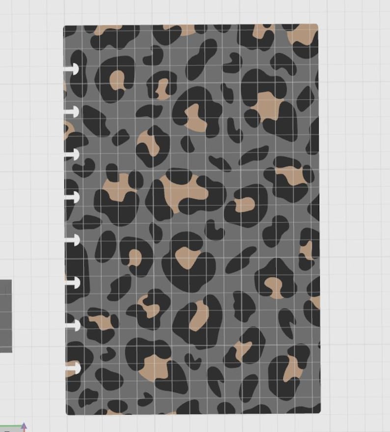 May include: A rectangular planner insert featuring a repeating leopard print pattern in shades of dark gray, black, and tan. The left edge of the paper has a series of small, evenly spaced cutouts designed for a disc-bound binding system.