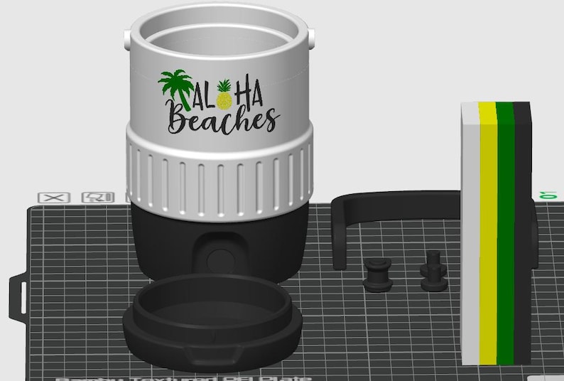 May include: A white and black cylindrical container with a textured upper band and a black base. The front features a green palm tree, a yellow pineapple, and the black text Aloha Beaches. Included are a separate black lid, two small black connectors, and a rectangular block with vertical white, yellow, green, and black stripes.