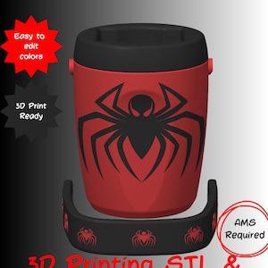 May include: A red and black cylindrical juice box holder featuring a black spider emblem on the front. The design includes a black base with small red spider icons. Text on the image reads: JUICE BOX HOLDER, Easy to edit colours, 3D Print Ready, AMS Required, 3D Printing STL & 3MF Files.