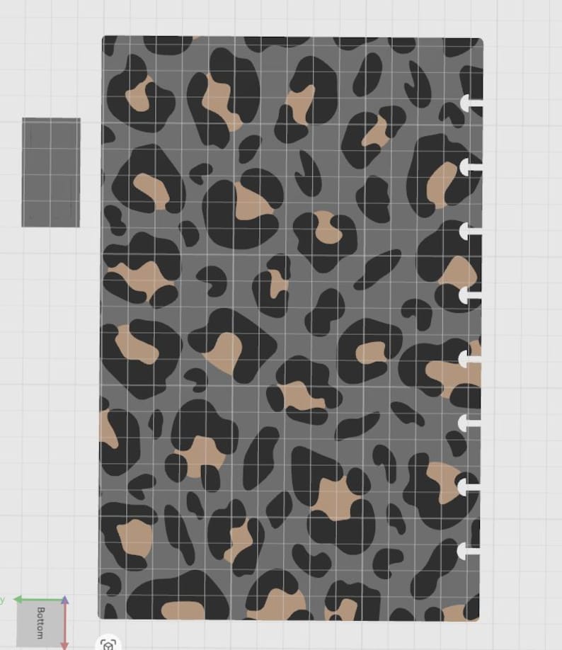 May include: A rectangular planner insert page featuring a gray background with a repeating black and tan leopard print pattern. The right edge of the page has a series of semi-circular cutouts designed for a disc-bound binding system.