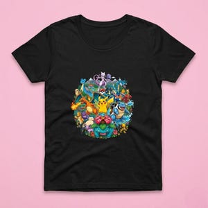 May include: Black t-shirt with a vibrant circular design showcasing numerous cartoon characters. The graphic includes a yellow Pikachu, a blue Blastoise, and a red Charizard, alongside other characters. The shirt is made of a soft material.