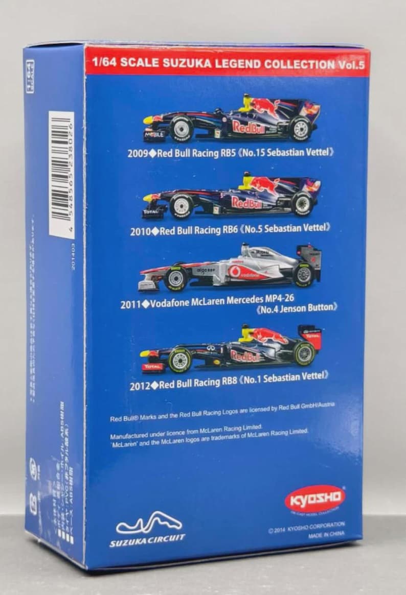 May include: A blue box featuring a 1/64 scale collection of Suzuka Legend race cars. The box displays images of Red Bull and McLaren Mercedes race cars from 2009-2012, including the drivers Sebastian Vettel and Jenson Button. The box has the text "KYOSHO" and "SUZUKA CIRCUIT".