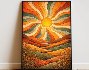 May include: A framed rectangular wall art print featuring a stylized sun with radiating wavy beams in shades of orange, yellow, and teal. The landscape below depicts rolling hills and fields of wildflowers in warm, earthy tones of gold and brown.