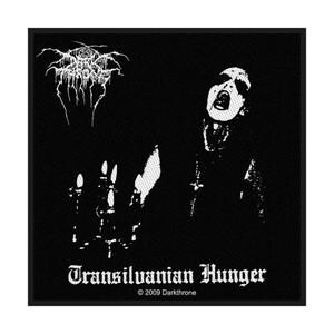 May include: A square black and white fabric patch featuring the Darkthrone logo at the top, a figure with corpse paint, a candelabra, the text Transilvanian Hunger, and the text 2009 Darkthrone at the bottom, all set against a solid black background.