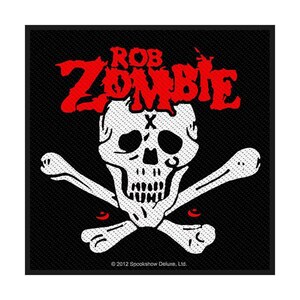 May include: Black square patch featuring a white skull with crossbones and red eyes. The name "ROB ZOMBIE" is written in red above the skull. The text "© 2012 Spookshow Deluxe, Ltd." is at the bottom.