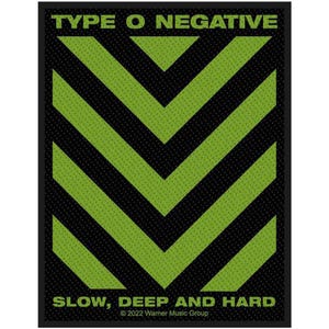 May include: A rectangular patch with the text "TYPE O NEGATIVE" and "SLOW, DEEP AND HARD". The design features green chevron stripes on a black background. The patch is a music-related item.
