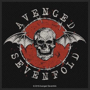 May include: A black fabric patch featuring a central red circle with a white skull and bat wings. The text "AVENGED SEVENFOLD" is printed in white around the circle, which is surrounded by barbed wire. The text "2019 Avenged Sevenfold" is at the bottom.