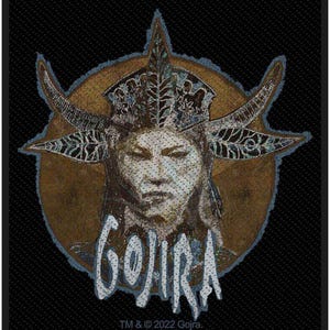 May include: A patch featuring a stylized illustration of a face with a crown and horns, set against a brown circle and a black background. The word "GOJIRA" is written in white, stylized lettering. The text "TM & © 2022 Gojira" is at the bottom.