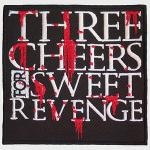 May include: A square black embroidered patch featuring the white text "THREE CHEERS FOR SWEET REVENGE" in a serif font. The letters are accented with red embroidery that mimics the appearance of dripping blood, creating a stark contrast.