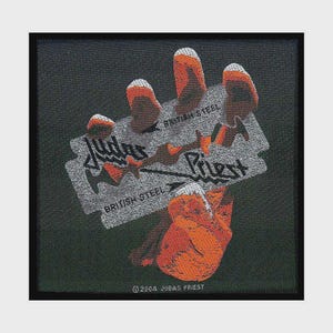 May include: A square black fabric patch featuring a graphic of a hand with orange-tipped fingers holding a silver razor blade. The text reads Judas Priest and British Steel, with the copyright text 2004 Judas Priest printed at the bottom edge.