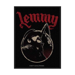 May include: A black patch with a red and white illustration of Lemmy Kilmister. The name "Lemmy" is in red at the top. The image shows a silhouette of Lemmy with a microphone and guitar. The text "© 2017 Lemmy Kilmister" is at the bottom.