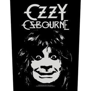 May include: A black and white rectangular fabric patch featuring a high-contrast graphic illustration of a face with long hair. The text OZZY OSBOURNE is printed in a stylized font at the top, with small copyright text at the bottom edge.