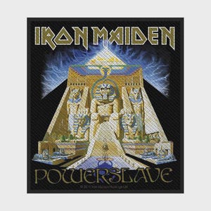 May include: A rectangular fabric patch featuring the Iron Maiden Powerslave album artwork. The design displays a central golden pyramid with Egyptian statues, a pharaoh figure, and blue lightning against a black background with text.