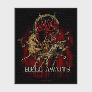May include: A rectangular black fabric patch featuring a graphic illustration of several horned, tan-colored demonic figures. Above the figures is the red Slayer logo, and below them is the white text HELL AWAITS in a bold, distressed font.