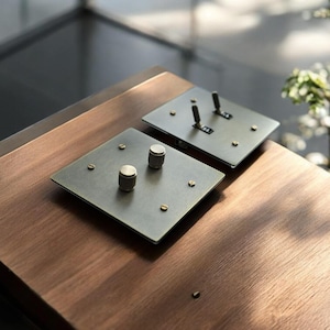 May include: A set of three ceramic mugs with a speckled, matte finish. Each mug is a different colour: light blue, cream, and grey. The mugs have a simple, modern design with a rounded shape and a handle.