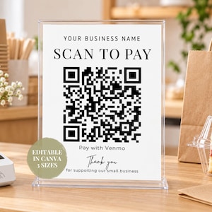 Peut inclure: Un porte-affiche en acrylique transparent contenant une carte blanche avec le texte noir YOUR BUSINESS NAME, SCAN TO PAY, Pay with Venmo et Thank you for supporting our small business, avec un grand code QR noir et blanc au centre.