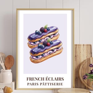May include: A framed print depicting two watercolour eclairs with purple icing, blueberries, and blackberries. The text "FRENCH ÉCLAIRS PARIS PÂTTISERIE" is printed at the bottom. The print is in a gold frame.