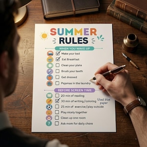 May include: A colorful "Summer Rules" checklist on blue paper, with sections for morning and screen time activities. A person is writing on the list with a pen. The list includes tasks like making the bed, eating breakfast, and playing outside.