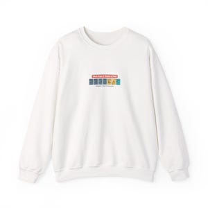 May include: White sweatshirt with a crew neck. The design features the text "Work Dope 3 Shades of Milk" above a row of colorful book icons. Below the text is the phrase "Modernistic Class of Thinking Milk."