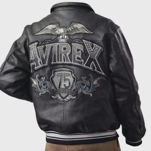 May include: Black leather bomber jacket with the word "AVIREX" embroidered across the back in silver and white. An eagle emblem is above the word, and a shield with the number "75" is below. The jacket has a ribbed collar and cuffs.