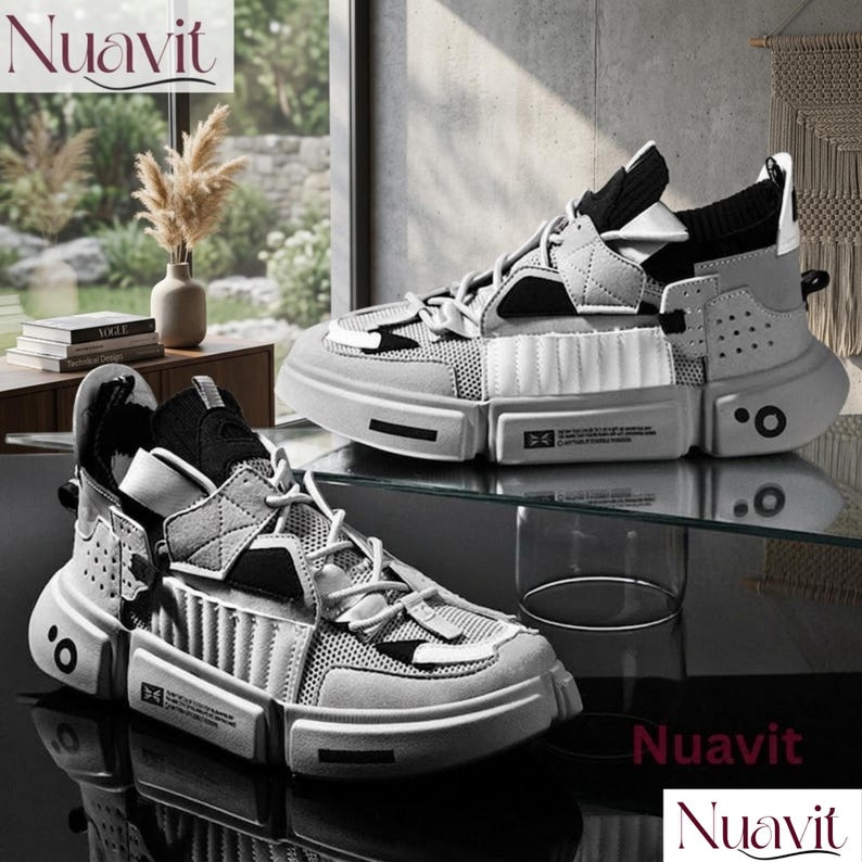 May include: A pair of modern, gray and white sneakers with a chunky sole. The shoes feature a mix of materials, including mesh and suede, with a unique geometric design. The brand name "Nuavit" is displayed in the upper left and lower right corners.