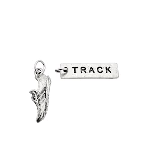 May include: Silver charm set featuring a running shoe and a tag that says "TRACK".