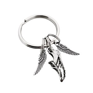 May include: Silver key chain with a running shoe charm and two angel wing charms.