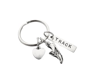 May include: Silver keychain with a heart charm, a running shoe charm, and a tag that says "TRACK".