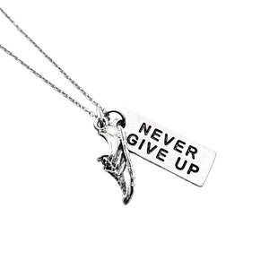 May include: A silver necklace with a silver charm that says "NEVER GIVE UP" and a silver shoe charm.