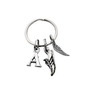 May include: Silver keychain with a letter A charm, a running shoe charm, and a wing charm.