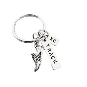May include: Silver keychain with a running shoe charm, a tag that says "TRACK" and a tag that says "XC".