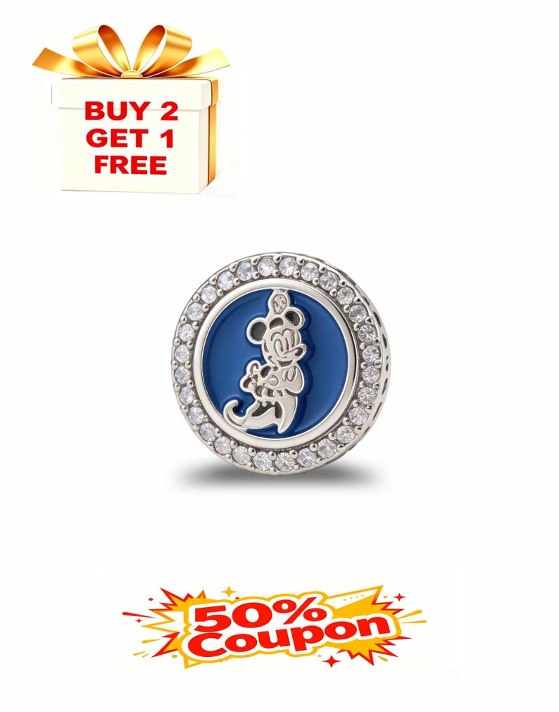 May include: A round, silver charm with a blue center featuring a Mickey Mouse design. The charm is encircled by a row of clear, sparkling stones. The image also includes a gift box with a gold bow and the text "BUY 2 GET 1 FREE".