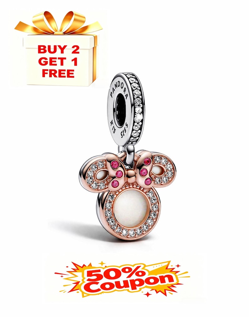 May include: A rose gold charm with a Minnie Mouse design. The charm features a round white center, a bow with pink accents, and is encrusted with clear crystals. The charm is attached to a silver Pandora branded loop.